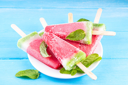 Tasty sweet watermelon ice cream lollies on blue wooden table, a Food & Drink Photo by Rimma