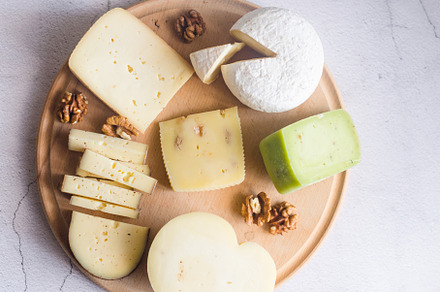 Delicious cheese mix with grapes, jam, snacks, crackers, walnuts, a Food & Drink Photo by vimart