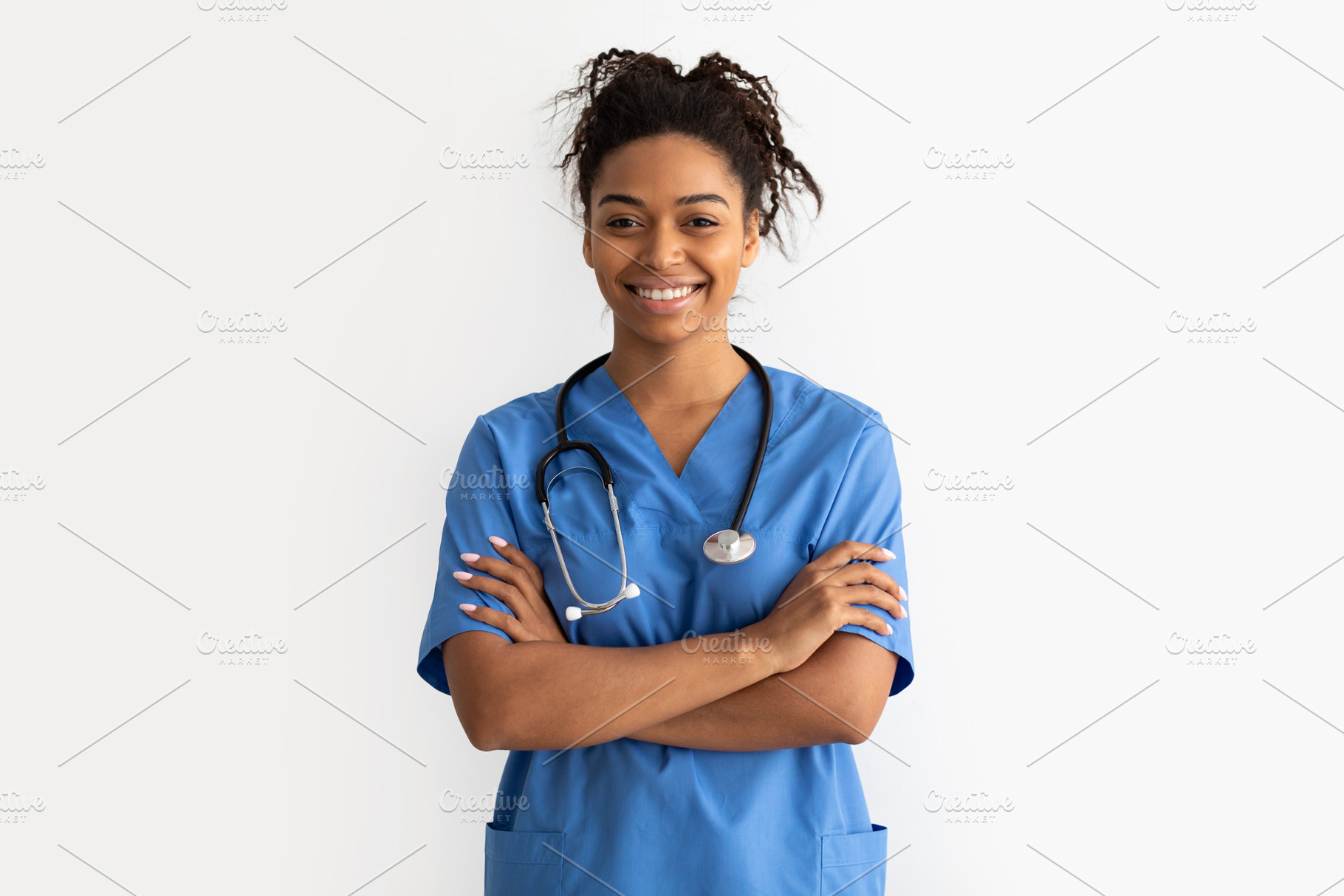 Portrait of black doctor looking at camera with folded arms, a Photo by Prostock-Studio