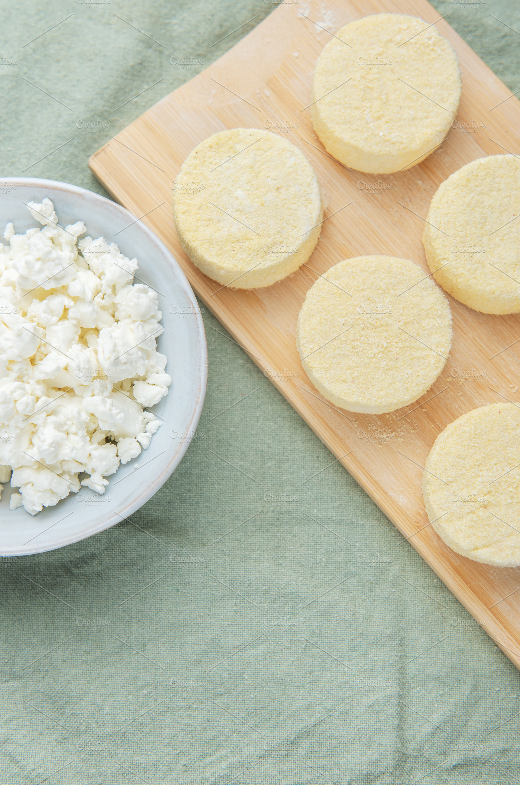 Syrniki preparation showcasing cottage cheese pancakes on cuttin, a Food & Drink Photo by Olena Rudo