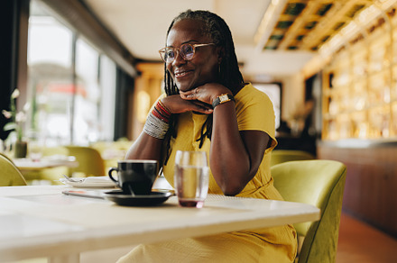 Happy senior woman sitting in a cafe, a Person Photo by Jacob Lund
