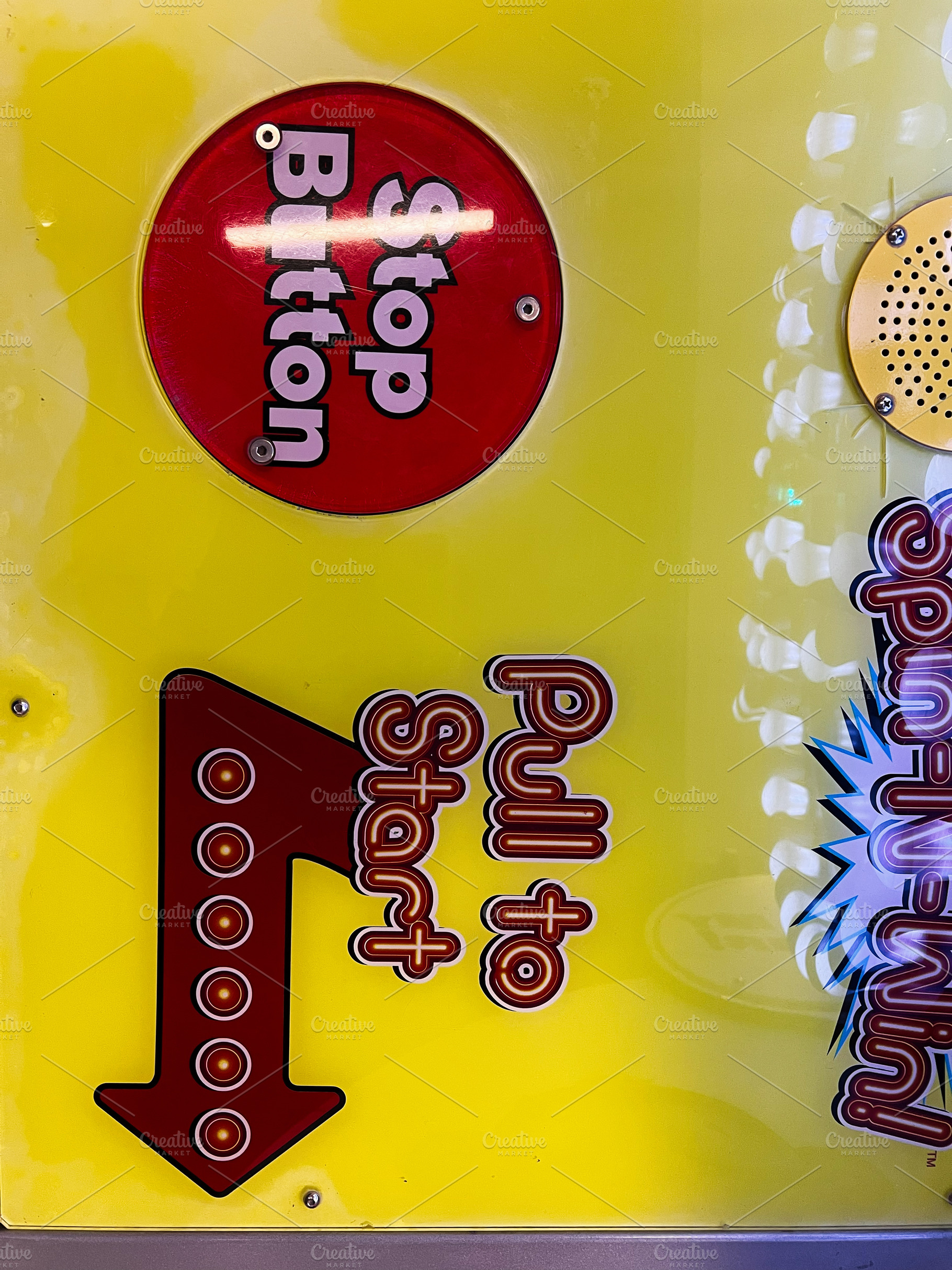 Colorful arcade panel featuring stop button and pull to start instructions, a Photo by AS photostudio