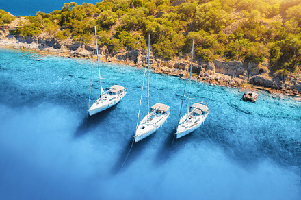 Aerial view of beautiful yachts, boats on the sea bay at sunrise, a Nature Photo by den-belitsky