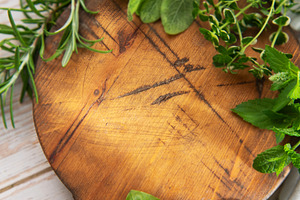 Fresh cooking herbs on rustic wooden cutting board, a Food & Drink Photo by Olena Rudo