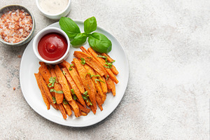 Sweet potato fries with ketchup and basil garnish, a Food & Drink Photo by Olena Rudo