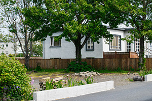 Charming suburban home surrounded by greenery on a quiet residential street, a Photo by AS photostudio