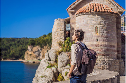 Young man tourist in the old town of, an Architecture Photo by Elizaveta Galitskaya