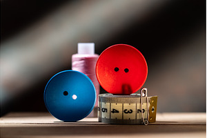 Red and blue buttons with threads, an Industrial Photo by Stockphoto by vzwer