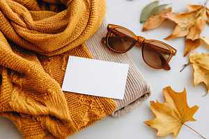 Vintage moodboard flat lay featuring a scarf, sunglasses, and autumn leaves, a Photo by AlyaAnd