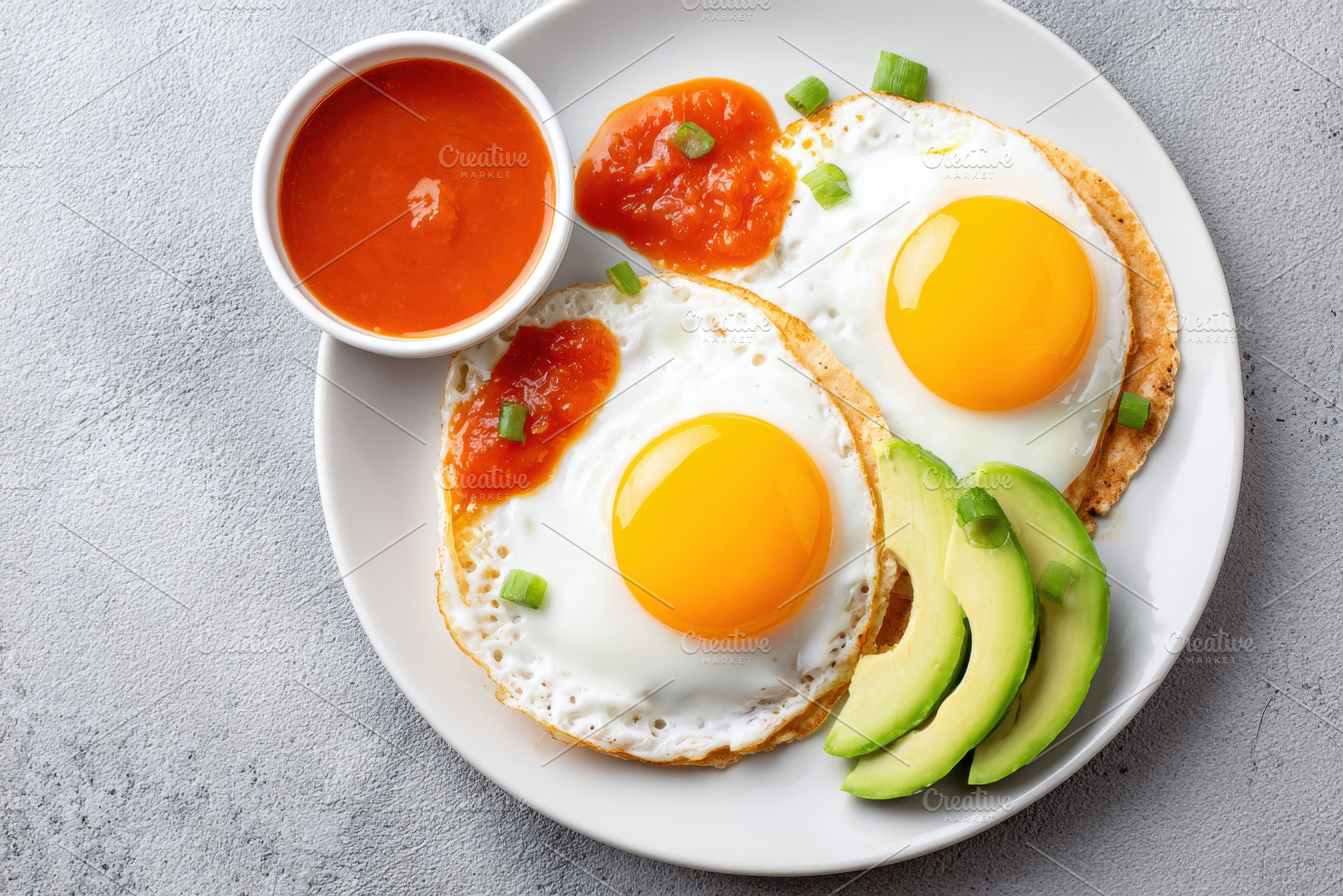 Sunny-side-up eggs with avocado and salsa, a Food & Drink Photo by AlyaAnd