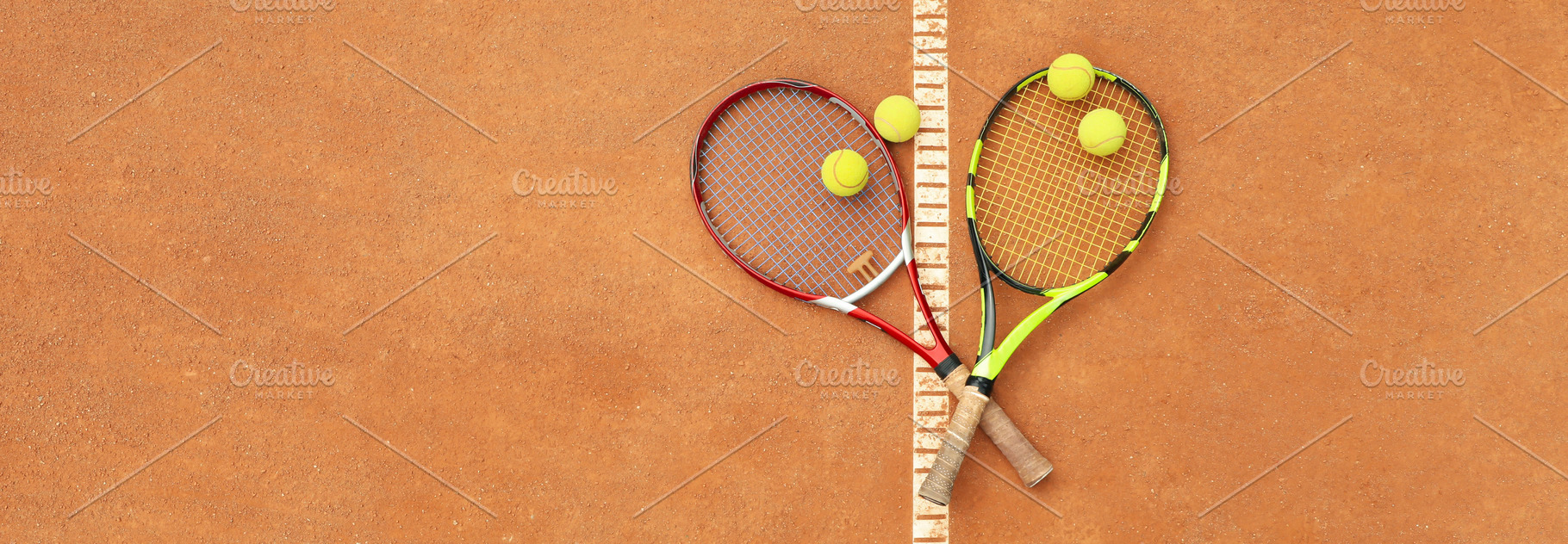 Tennis racquets with tennis balls on clay court, a Sports & Recreation Photo by AtlasStudio PRO