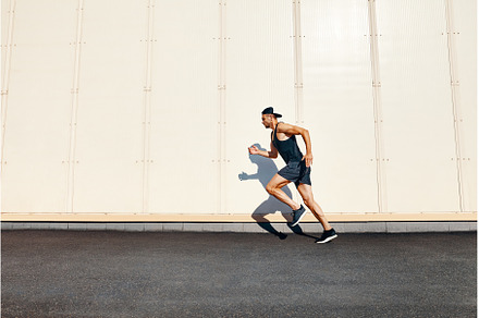Young man runner running along wall, a Sports & Recreation Photo by Gladkov photography