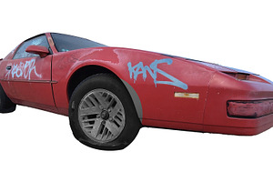 Graffitied abandoned red sports car isolated photo, a Transportation Photo by DanFLCreativo