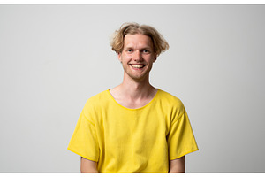 Smiling blonde man wearing a yellow, a Person Photo by volodymyrshtun13795