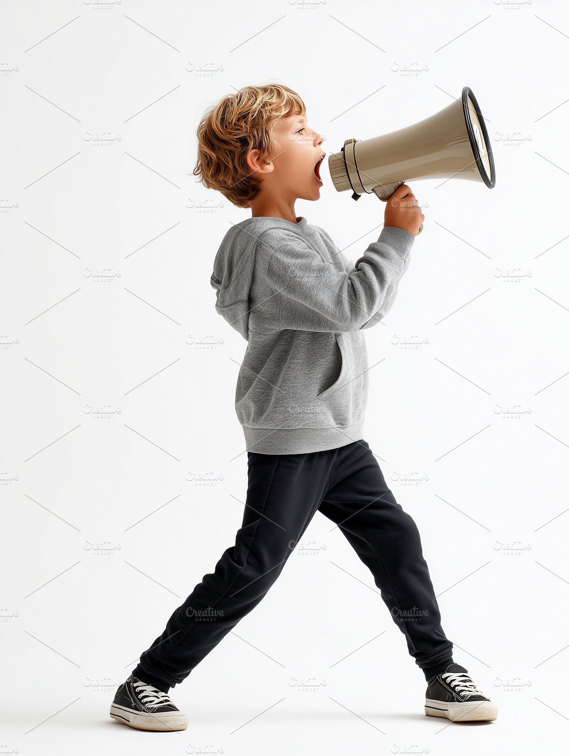 Young boy shouting into a megaphone, a Person Photo by MistyDay