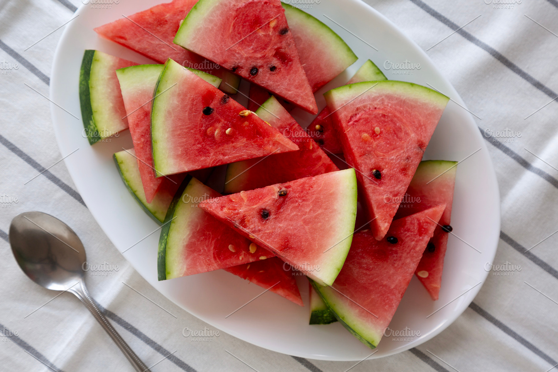 Raw Organic Watermelon Slices on a Plate, top view. Flat lay, ov, a Food & Drink Photo by LiudmylaChuhunova