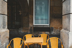 Empty cafe table with yellow chairs, an Architecture Photo by SkyNext