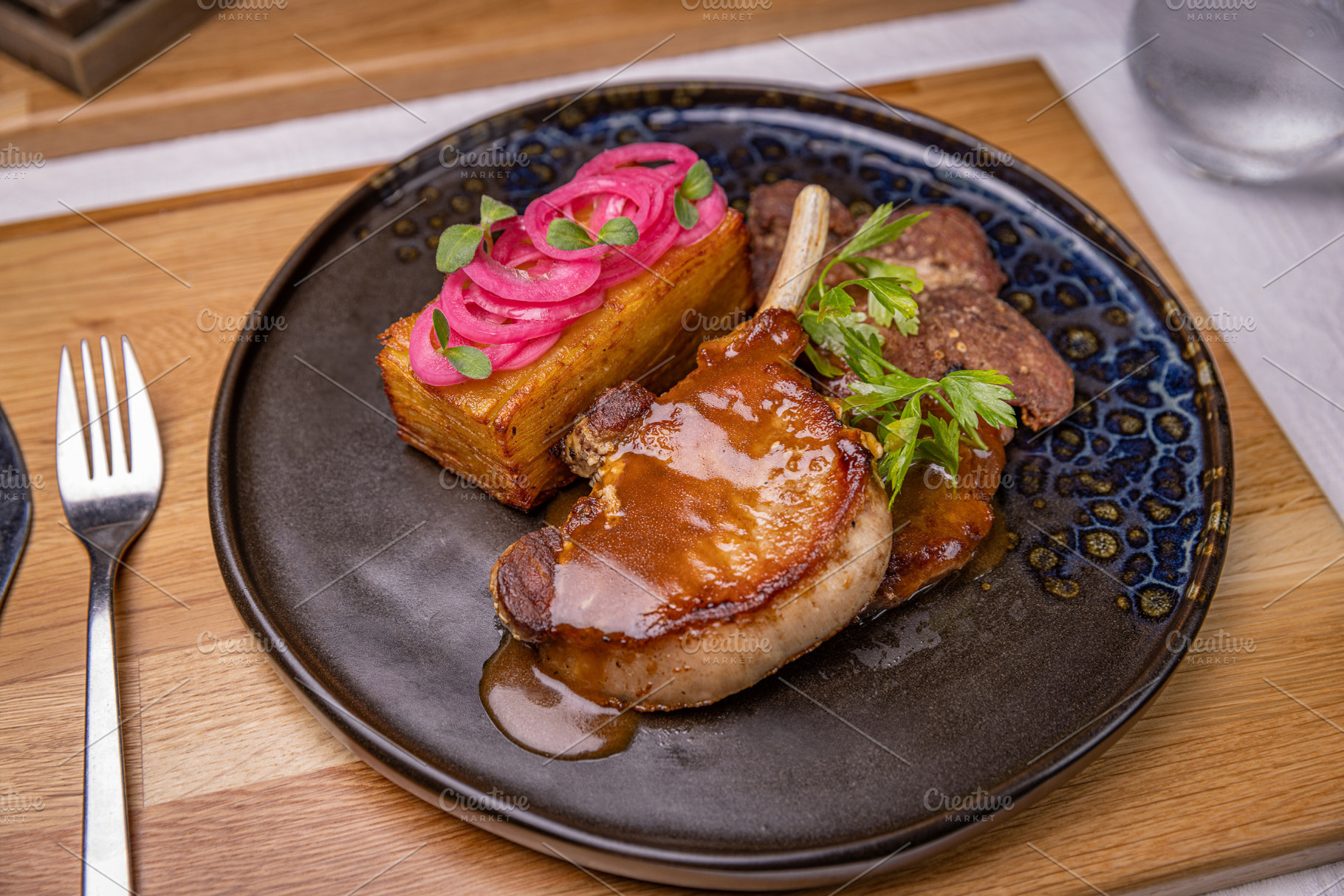 Grilled pork chop with potato gratin, a Photo by Grafvision photography