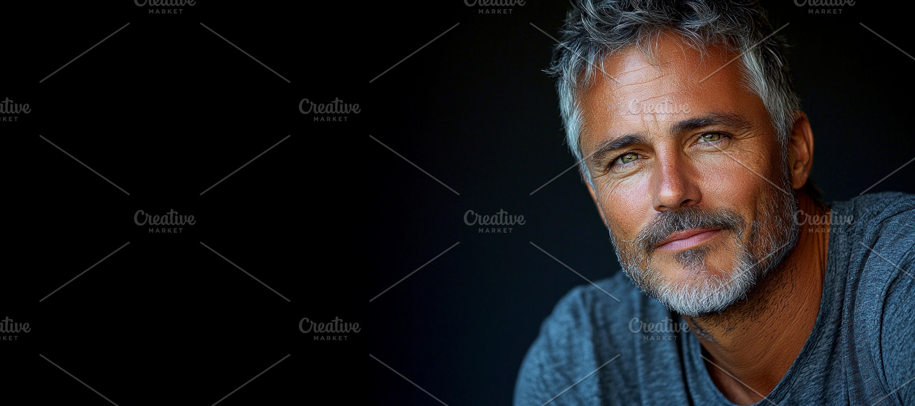 Confident mature man with gray hair and beard wearing a gray shi, a Person Photo by José Manuel Gelpi