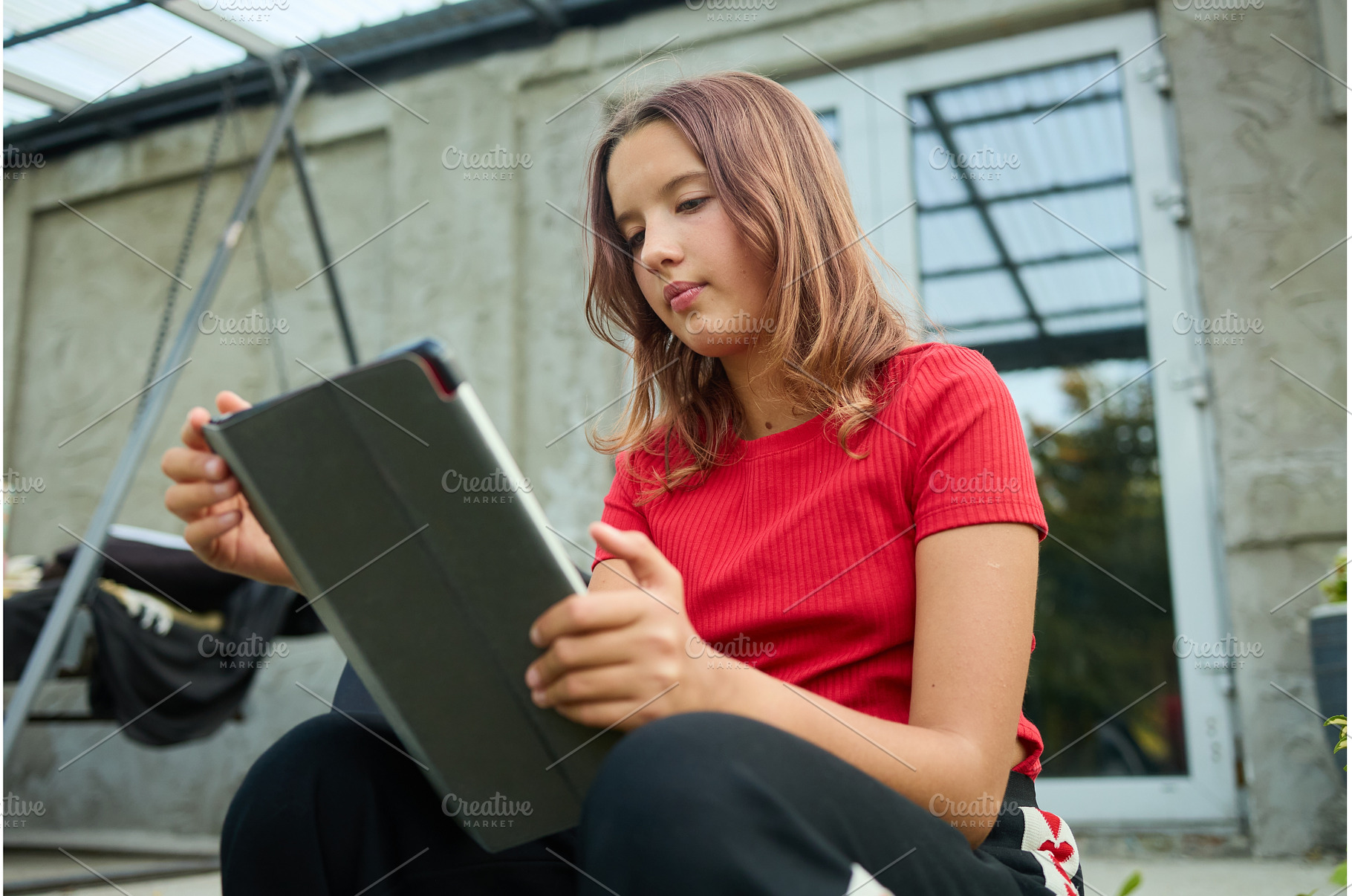 School girl uses tablet while, a School & Education Photo by IlliaBondarPhotography
