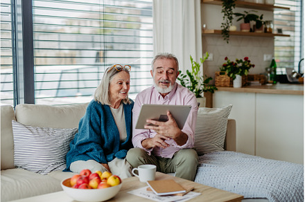 Senior couple scrolling tablet in, a Person Photo by HalfPoint