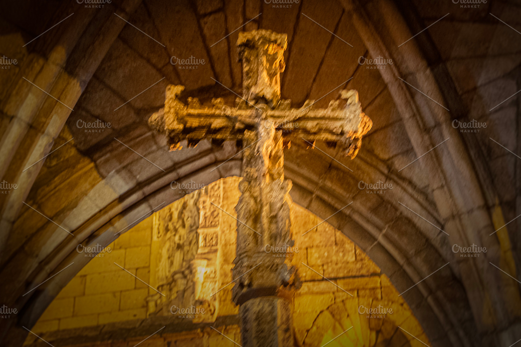 Stone cross under gothic arch inside medieval chapel, a Photo by DanFLCreativo