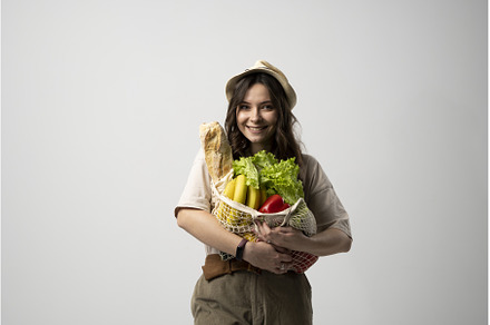 Woman holding cotton grocery bag, a Food & Drink Photo by volodymyrshtun13795