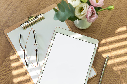 Stationery workspace with a blank tablet, notebook, and flowers, a School & Education Photo by Olena Rudo