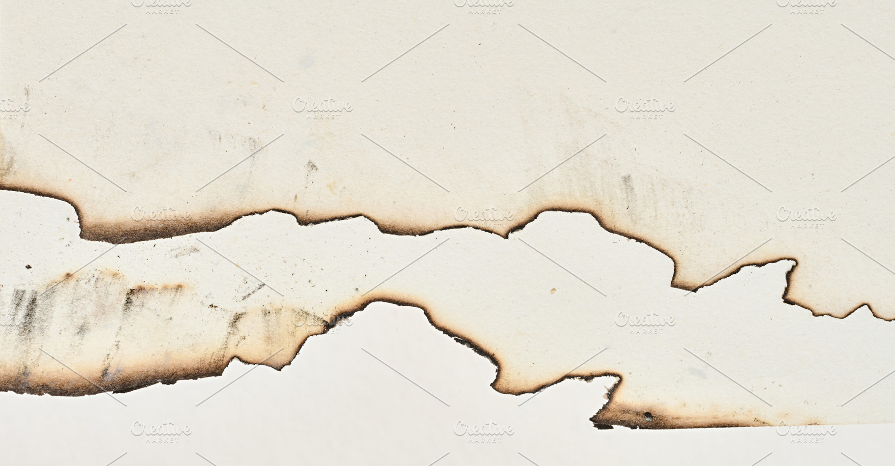 Burnt edges of blank white notebook sheets, a Background Photo by ndanko
