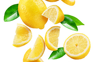 Ripe lemon fruits, slices and leaves flying in air white backgro, a Food & Drink Photo by Volff