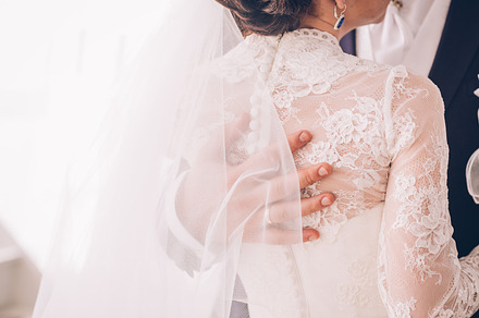 Groom hand on brides dress, a Person Photo by ruslan117