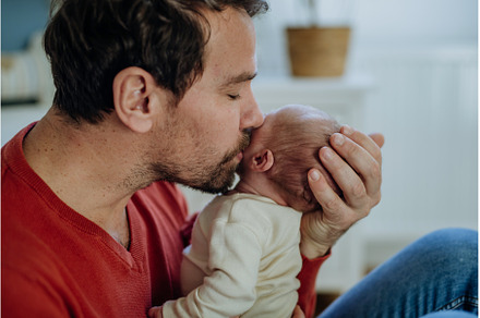 Close-up of father kissing his, a Person Photo by HalfPoint