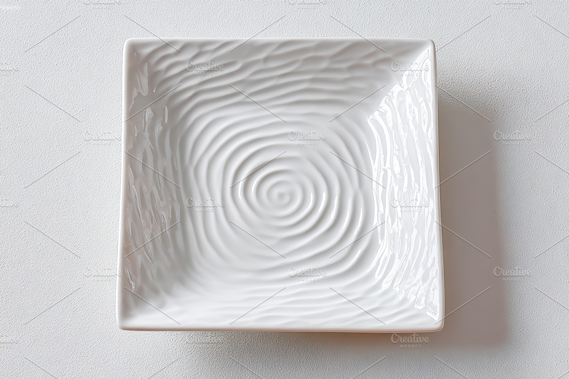 Square ceramic plate with textured matte design suitable for modern dining deco, a Food & Drink Photo by AlyaAnd