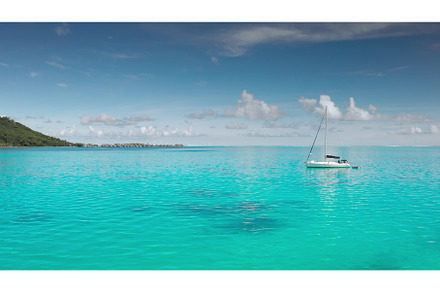 Sailboat floating on turquoise water