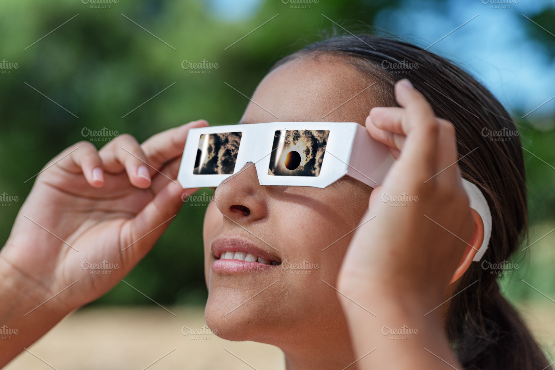Young girl watches a solar eclipse, a School & Education Photo by Volff