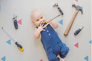 Adorable baby in a mechanic costume, an Industrial Photo by Elizaveta Galitskaya