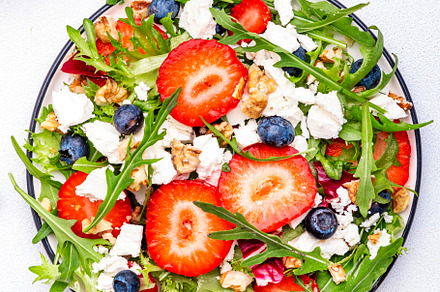 Strawberry salad with arugula, lettuce, blueberries, feta cheese, a Food & Drink Photo by 5PH