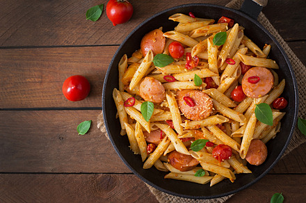Penne pasta with tomato sauce containing background, basil, and bolognese, a Food & Drink Photo by timolina