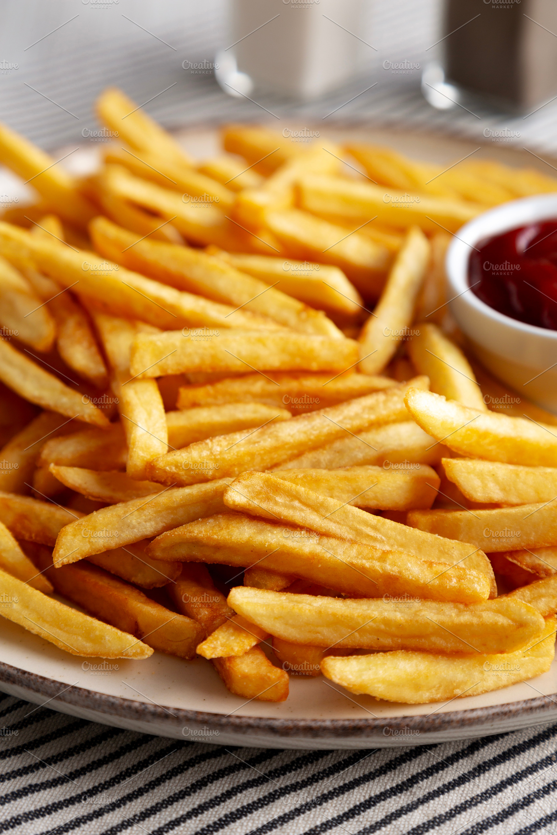 Homemade Golden French Fries with Ketchup, side view. Close-up., a Food & Drink Photo by LiudmylaChuhunova