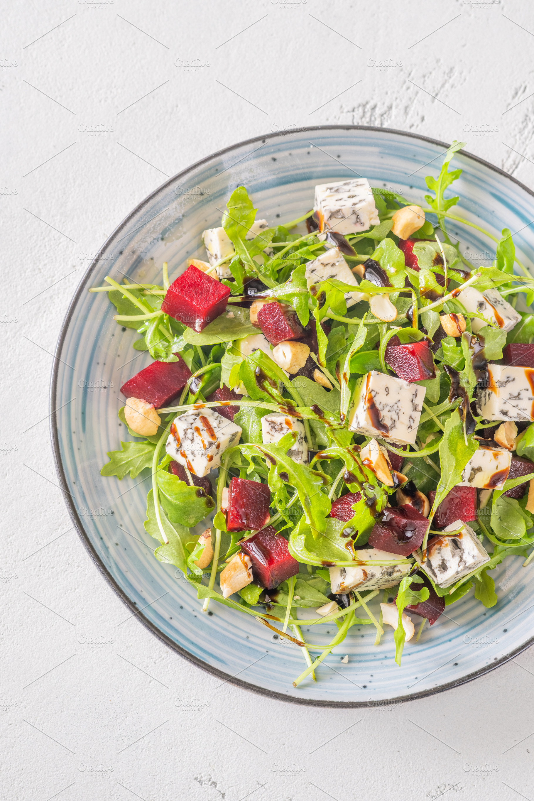 Beetroot arugula salad with blue cheese nuts and balsamic glaze, a Food & Drink Photo by Alexander Prokopenko