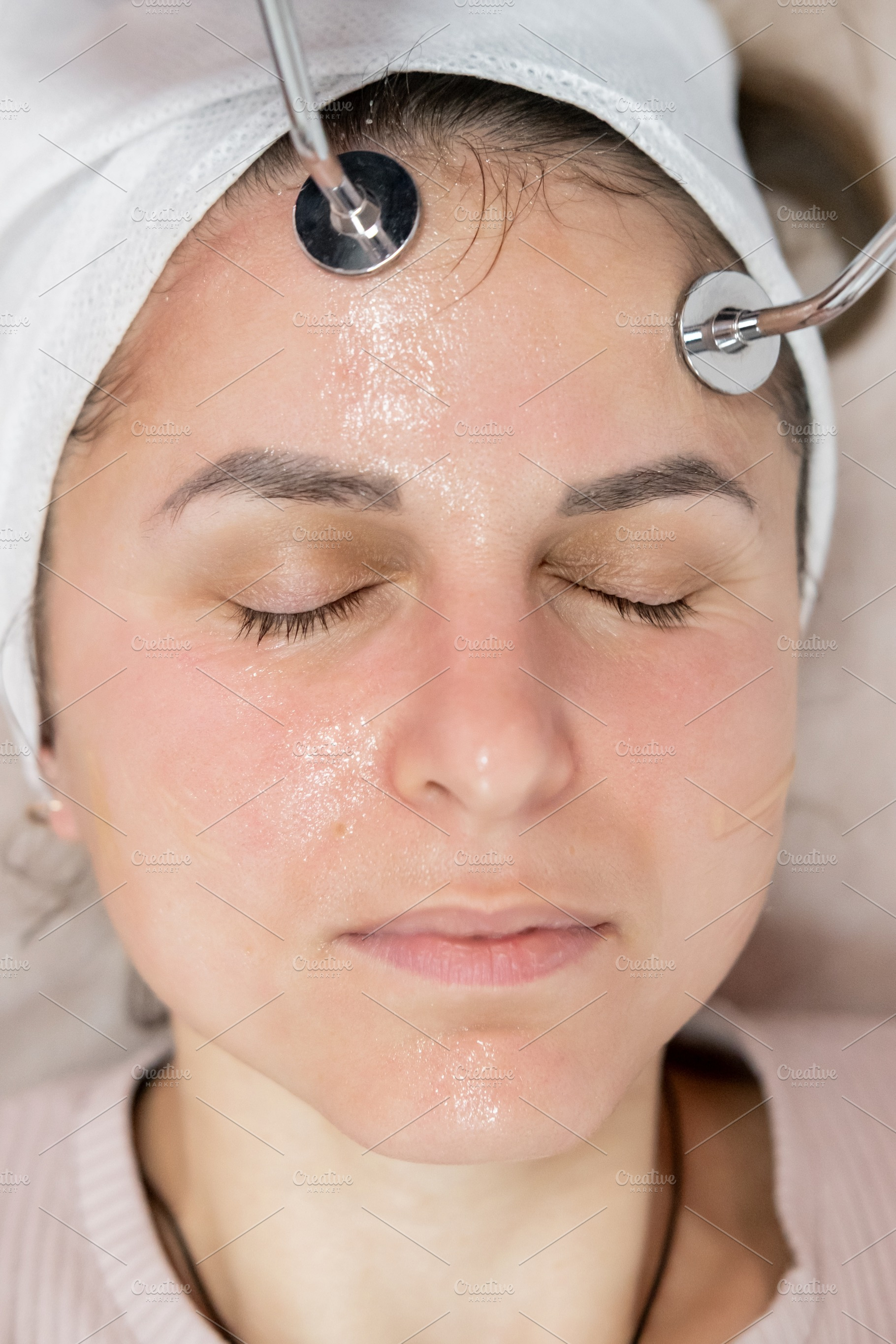 Woman face microcurrent stimulation procedure, a Person Photo by Photo Drive Studio