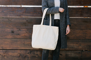 Woman holding white textile tote eco