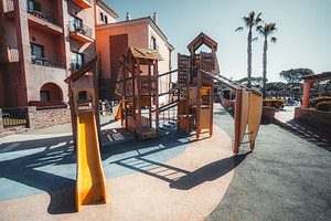 Sunny playground by a building, a Sports & Recreation Photo by SkyNext