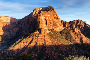 Hiker overlooking vast red rock canyon in Utah with blue sky and dramatic cliff, a Nature Photo by AS photostudio