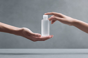 Hands exchanging a clear bottle, a Photo by Beautiful things