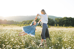 Mother with child girl in flowers