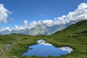 Small alpine pond reflecting Mont Blanc peaks, France, a Nature Photo by GoodGoods