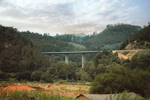 Bridge over green Spanish valley, a Transportation Photo by SkyNext