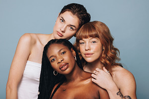 Women with different skin tones standing together, a Person Photo by Jacob Lund