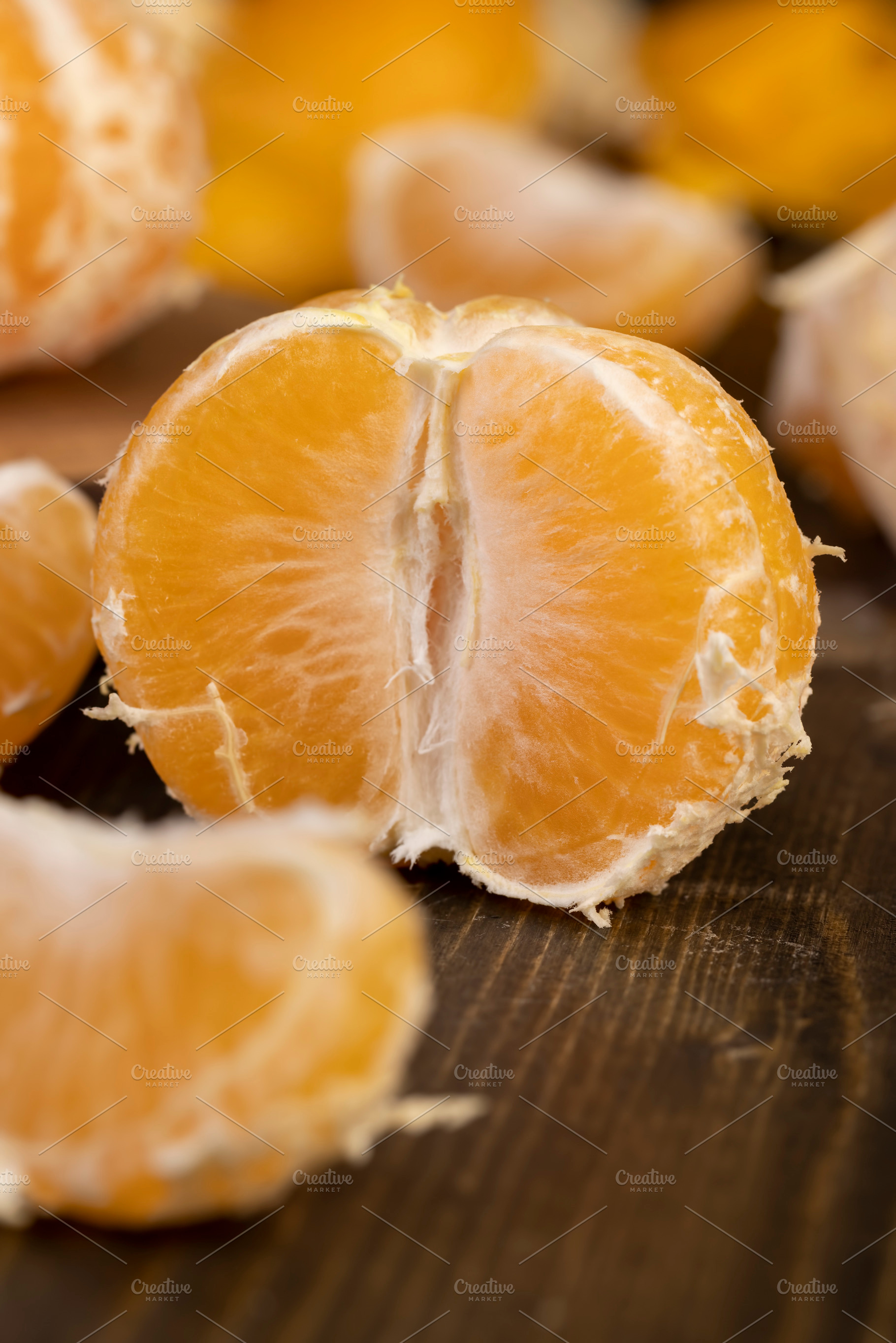 peeled orange ripe tangerines on the table, a Photo by rsoollAI